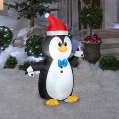 an inflatable penguin wearing a santa hat