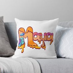 a pillow with the word pepo on it sitting on a couch next to pillows