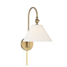 a wall light with a white shade on the side and a gold finish frame,