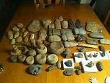 a wooden table topped with lots of rocks and other items on top of it's surface