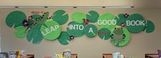 some bookshelves are decorated with green leaves and read - it - yourself signs