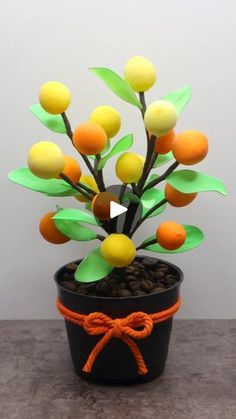 a potted plant with oranges and green leaves