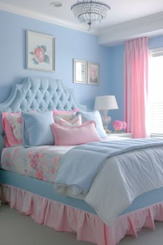 a bedroom with blue walls, pink and white bedspread, chandelier and curtains