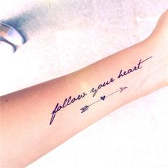 a woman's arm with an arrow and the words follow your heart on it