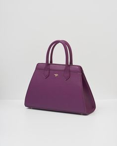 Our classic tote has been beautifully updated with our Floral Engravings Print. Crafted from recycled faux leather in plum and featuring a twilly scarf wrapped around the handle. With ample space and luxe gold-tone hardware, it’s perfect for carrying books and souvenirs from your favorite exhibitions.

Key features:


Outer: 100% Polyurethane; Lining: 100% Polyester Scarf: 100% Polyester



Approx. 34 (L) x 21 (H) x 12 (D) cm



Wipe clean with a damp cloth Timeless Bag With Adjustable Double Handle, Elegant Purple Shoulder Bag, Luxury Purple Satchel With Handles, Classic Bags With Adjustable Round Handle, Classic Bag With Adjustable Round Handle, Elegant Purple Rectangular Shoulder Bag, Luxury Purple Formal Bag, Luxury Purple Formal Bags, Luxury Purple Bag With Top Carry Handle