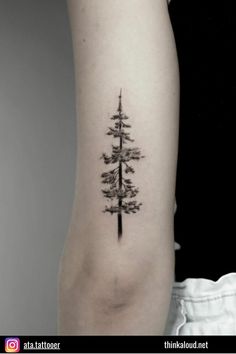 a small pine tree tattoo on the arm