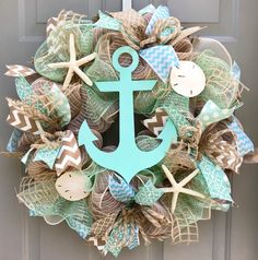 a wreath with an anchor, starfish and seashells on it