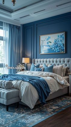 a large bed sitting in the middle of a bedroom next to a window with blue curtains