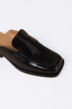 The Alfred is a mule loafer with squared-toe uppers and no back. It’s crafted from black leather and has rubber soles and slight heels. Slip them on with jeans and a french-tucked button-down, or trousers and a trench coat – it goes without saying that this is the perfect transitional shoe. 100% Sustainable Leather Ethically Made in Portugal Formal Sleek Square Toe Mules, Classic Flat Heel Mules For Formal Occasions, Chic Slip-on Loafers With Square Toe, Formal Slip-ons With Square Toe And Leather Sole, Evening Loafers With Leather Sole And Square Toe, Evening Loafers With Square Toe And Leather Sole, Evening Square Toe Loafers With Leather Sole, Chic Loafers With Square Toe And Leather Sole, Black Square Toe Loafers For Business