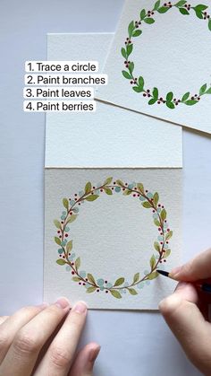 someone is making a christmas wreath card with watercolors