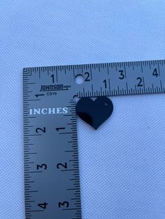 a ruler with a heart shaped magnet on it