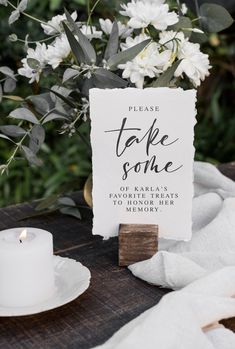 a table topped with white flowers and a sign