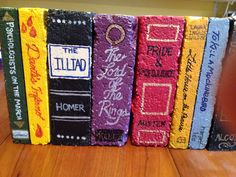 a row of books sitting on top of a wooden table