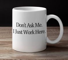 a white coffee mug that says, don't ask me i just work here