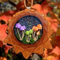 an ornament with mushrooms and moss in it