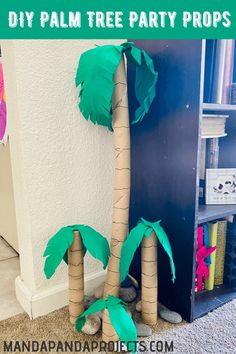 two palm trees made out of toilet paper on the floor with text overlay that reads diy palm tree party props