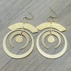 Look like the star of the night with these Large Gold Statement Hoop Earrings! Crafted with a brass gold finish and textured crescent hoops, these earrings will have you turning heads with the perfect combo of sophistication and style. Feeling sassy? Rock these out for a look that's out of this world! Brass textured components Brass ear hooks Length is 4" Created in studio - Wilmington, NC Gold Crescent Hoop Earrings With Hammered Detail, Gold Hammered Crescent Hoop Earrings, Gold Crescent Hammered Earrings, Gold Hammered Crescent Earrings, Modern Crescent Brass Hoop Earrings, Gold Crescent Hoop Earrings In Brass, Gold Crescent Hoop Earrings With Ear Wire, Statement Hoop Earrings, Brass Texture