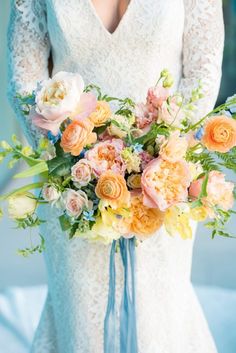 a bride holding a bouquet of flowers in her hands