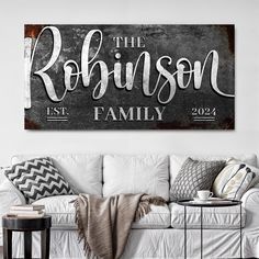 the personalized family name sign is displayed on a white couch