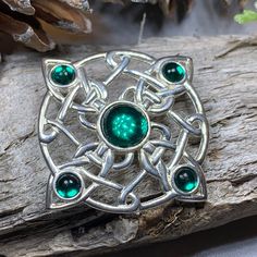 "Antique Style Celtic Brooch with your choice of color crystal detail.   A beautiful combination of sterling silver plated pewter that makes the crystal cabochons pop! Your choice of green, red, purple or blue crystals with one large 3 carat focal crystal and 4 smaller accent crystals.  The Celtic Knotwork was used to illustrate the Book of Kells and the Book of Durrow by ancient monks (monks who started the Book of Kells on the island of Iona, Scotland). Celtic knotwork is widely used and seen across Scotland and Ireland, this symbol is said to bring good luck, health or prosperity, or to represent luck and long life. These types of Celtic knotwork brooches were used for centuries to hold cloaks, tartans, and to decorate dresses and clothing by Irish and Scottish nobility and warriors. Th Scottish Nobility, Iona Scotland, Celtic Brooch, The Book Of Kells, Pewter Plates, Tree Of Life Jewelry, Wiccan Jewelry, Book Of Kells, Celtic Knotwork