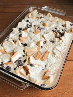 a casserole dish is shown on a wooden table and has raisins in it