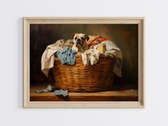 a painting of a dog sitting in a basket with clothes on the floor next to it