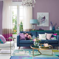 a living room filled with furniture and a chandelier