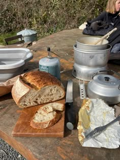 a wooden table topped with lots of food and cooking utensils on top of it