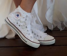 the bride's shoes are adorned with pearls