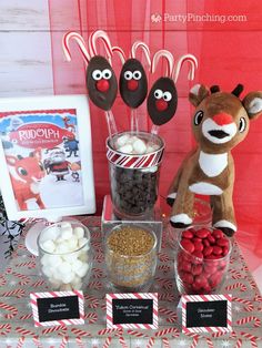 a christmas dessert table with candy, candies and rudolph the red nosed reindeer decorations