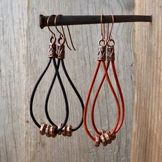 These are great boho, leather and copper earrings. You have a choice of black or brown leather on these earrings. They could be made another length if you prefer larger. The copper beads slide freely on the leather. The leather is 1.5mm in thickness. These hang 3 inches in total length. If you prefer copper ear wire, that choice is available too. As always, these earrings are available with pure titanium ear wire. I use only grade 1, pure titanium wire. The colored wire has no dyes or chemicals Everyday Brown Metal Earrings, Copper Beaded Teardrop Earrings For Gifts, Artisan Copper Beaded Earrings For Gift, Adjustable Rust Earrings With Ear Wire, Adjustable Minimalist Copper Earrings, Adjustable Brown Wire Wrapped Earrings, Adjustable Black Copper Earrings, Adjustable Wire Wrapped Brown Earrings, Rustic Copper Earrings With Ear Wire