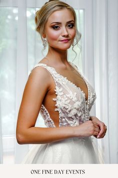 a woman in a wedding dress posing for the camera