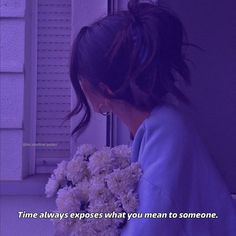 a woman holding flowers in front of a window with the quote time always exposes what you mean to someone