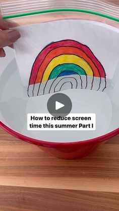 someone is drawing a rainbow on a paper in a red bowl with the words how to reduce screen time this summer part 1