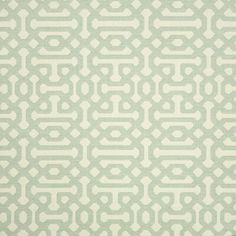 a green and white rug with an abstract design