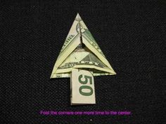 an origami dollar bill is folded into a triangle with the word $ 50 below it