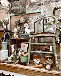 an assortment of items displayed on top of a shelf in a room filled with bird cages and other things