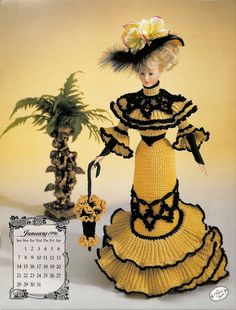 a crocheted doll is posed next to a potted plant and a calendar