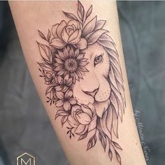 a woman's leg with a lion and flowers on it