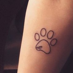 a dog paw tattoo on the right arm and leg, with an arrow in the middle