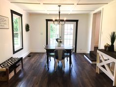 a dinning room table with chairs and a bench