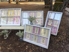 three framed pictures sitting on top of a wooden bench next to a tree in a park