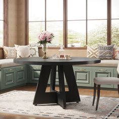 a kitchen table with two chairs and a bench in front of the window next to it