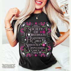 a woman with blonde hair wearing a black t - shirt that says, i am the society