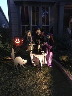 three halloween decorations in front of a house