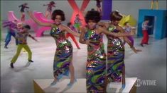 group of women in disco outfits dancing on stage