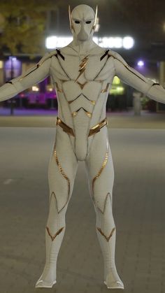 a man dressed in white and gold stands on the street at night with his arms outstretched