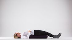 a woman laying on the ground with her legs spread out in front of her head