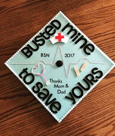 a blue graduation cap with the words bused mine to be yours and nurse's cross on it