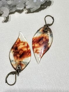 Images of a smoldering, bronze smoke in glass-like resin.  Dangling 1.5" from elegant bronze locking hooks. Wonderful for any occasion: weddings, work, special occasions, dress up, etc!  Leaf images are encased in double layers of jewelry grade resin for durability. All paid orders will be shipped within 2-3 business days unless otherwise noted. In an effort to go green, I do not print out receipts but will happily email you a copy upon request! Do you need faster shipping? Message me! Vintage Amber Resin Jewelry, Vintage Resin Jewelry For Parties, Vintage Resin Jewelry For Party, Elegant Nickel-free Resin Jewelry, Elegant Resin Dangle Jewelry, Elegant Resin Drop Earrings, Elegant Dangle Resin Jewelry, Nickel-free Resin Jewelry With Unique Style, Unique Nickel-free Resin Jewelry